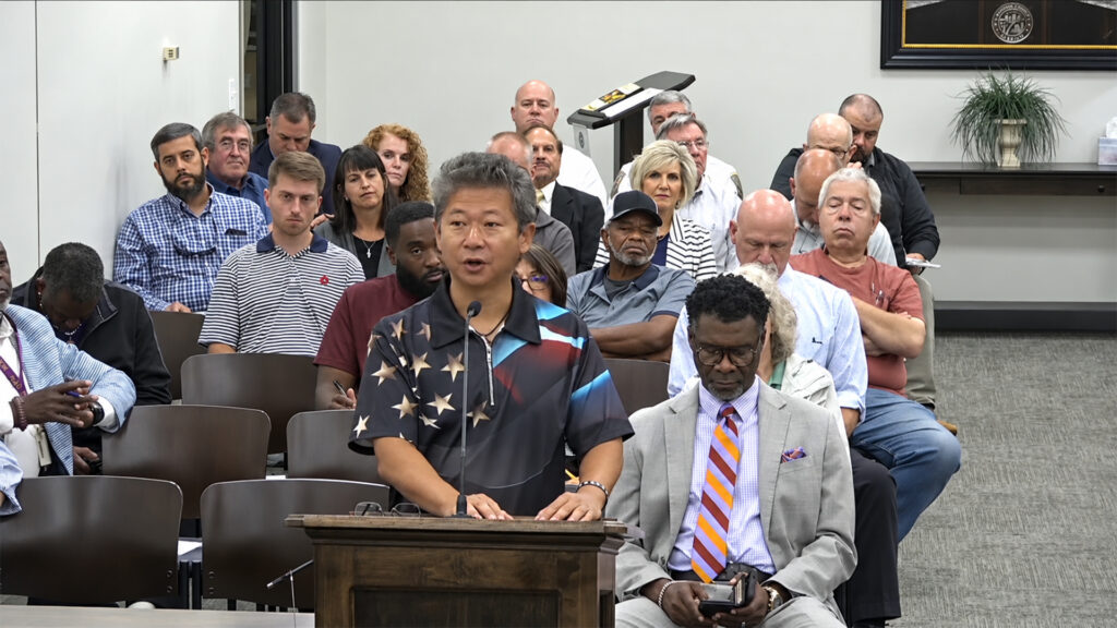 A speaker addresses Madison County commissioners from the podium during the September 23, 2026, meeting.