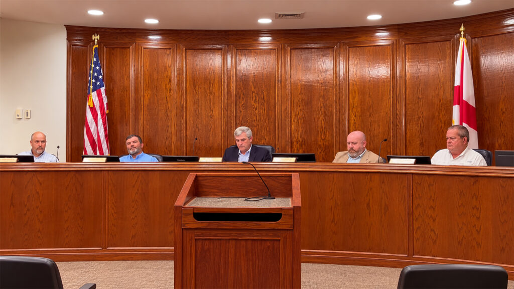 AI-assisted composite showing Autauga County commissioners seated behind the dais during the September 15, 2026, commission meeting.